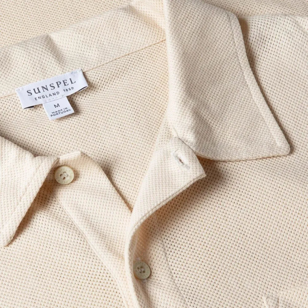 Close-up of the collar of the Sunspel Riviera Polo Shirt Undyed showing the natural cotton mesh texture and refined neckline.