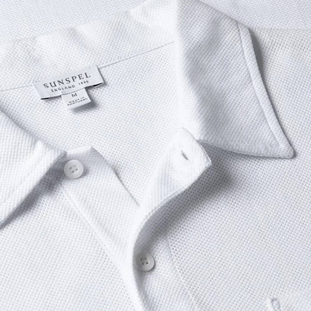 Close-up of the collar of the Sunspel Riviera Polo Shirt Undyed showing the natural cotton mesh texture and refined neckline.