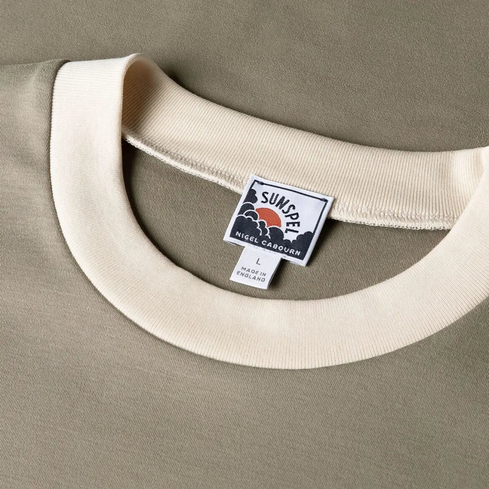 Close-up of the collar of the Sunspel x Nigel Cabourn Carbon Brushed T-shirt Earth showing the brushed cotton texture and refined neckline.