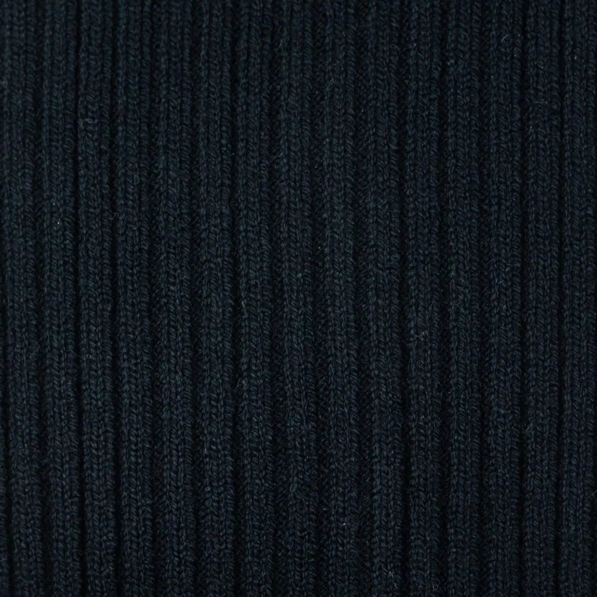 Close-up of the black ribbed knit texture on Tabio Power Rib Long Calf Socks
