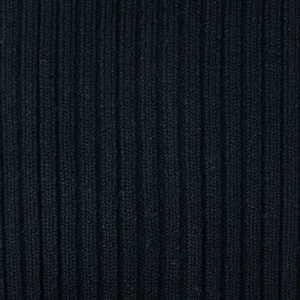 Close-up of the black ribbed knit texture on Tabio Power Rib Long Calf Socks