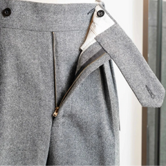 Close-up of the waistband of the Tangent TAN02 Henry Hard Classic Tweed Herringbone Light Grey trousers showing adjusters and button details.