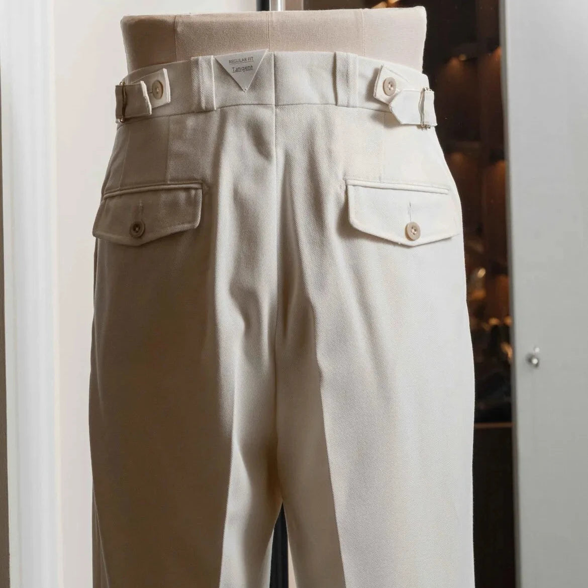 Rear view of the Tangent Tan 04° Charles Hard Twist Twill Off White trousers featuring the back pockets and clean drape.