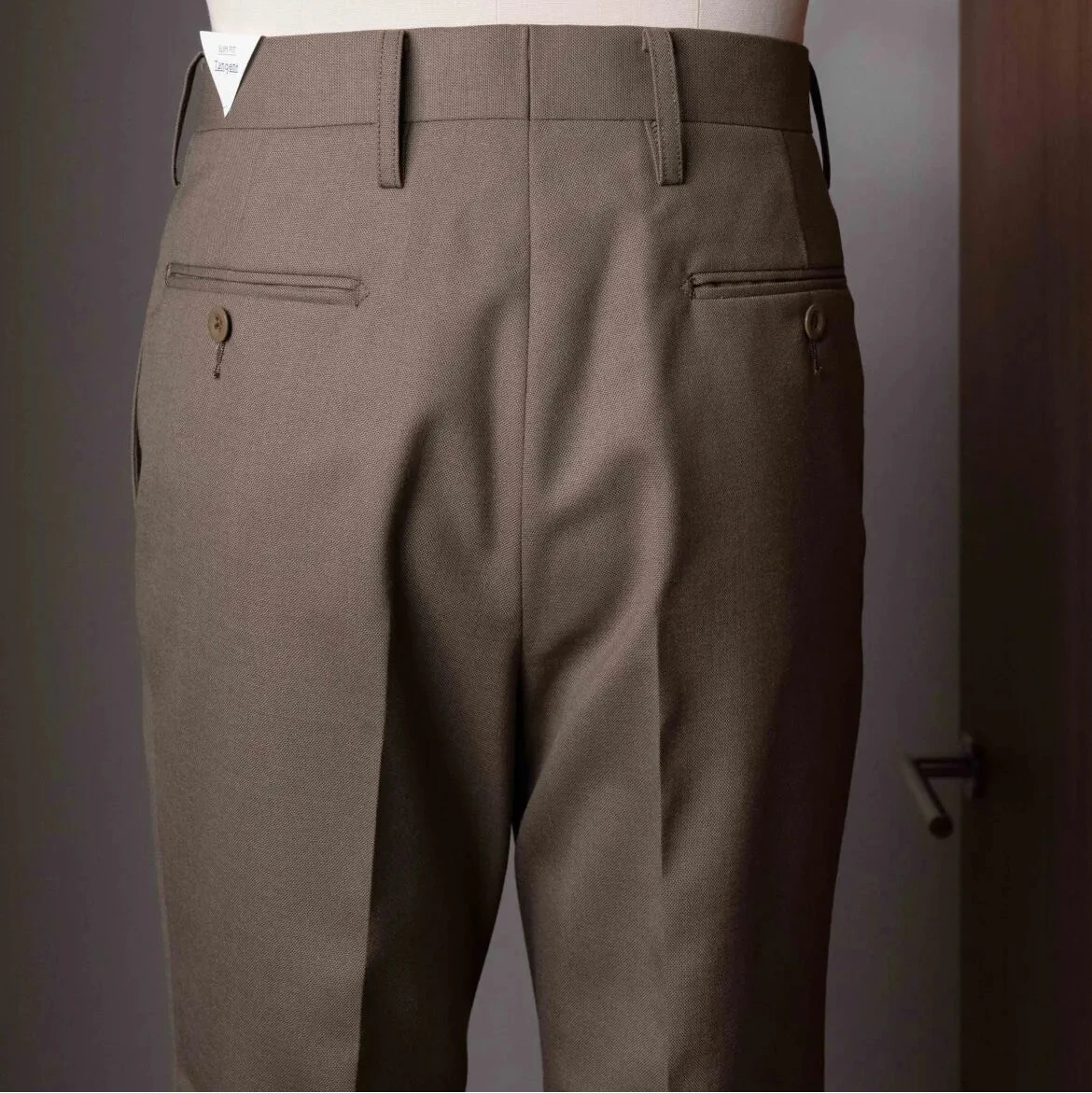 Rear view of the Tangent TAN24 Pepe Khaki trousers featuring the back pockets and smooth construction.