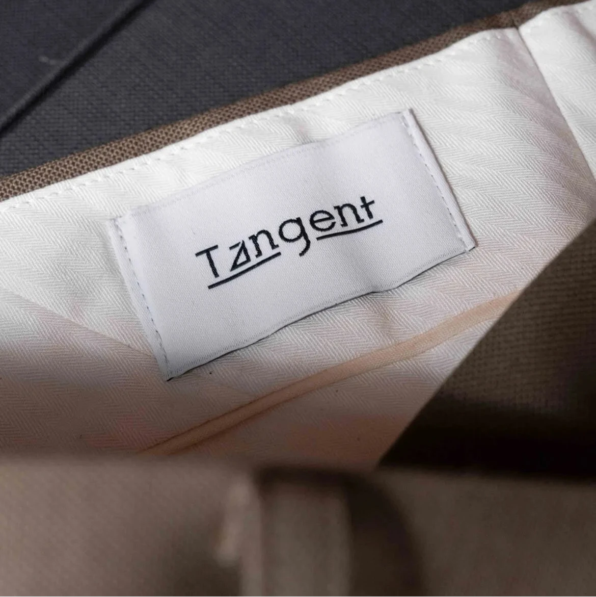 Close-up of the inner label of the Tangent TAN24 Pepe Khaki trousers showcasing branding and craftsmanship.