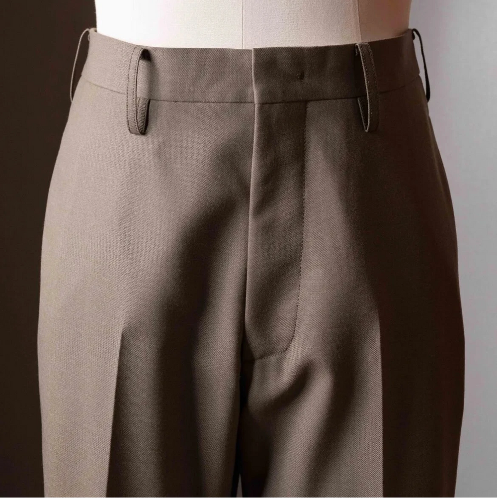 Close-up of the waistband of the Tangent TAN24 Pepe Khaki trousers showing adjusters, stitching, and button detailing.