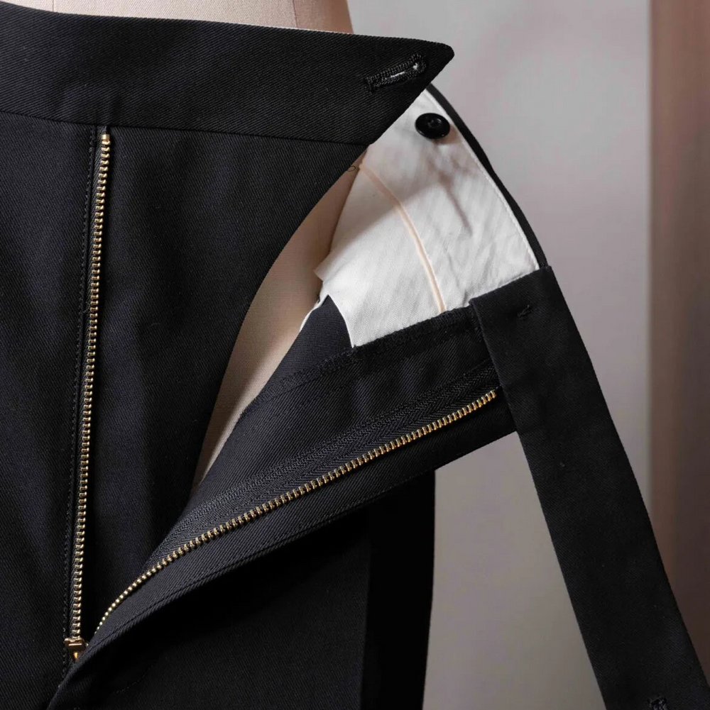 Close-up of the waistband of the Tangent TAN25 Pat Black trousers showing the adjusters and button details.