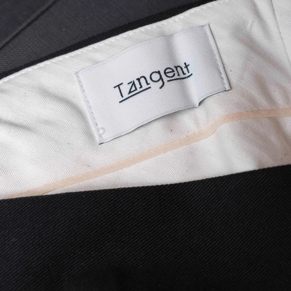 Close-up of the inner label of the Tangent TAN25 Pat Black trousers showcasing branding and craftsmanship.