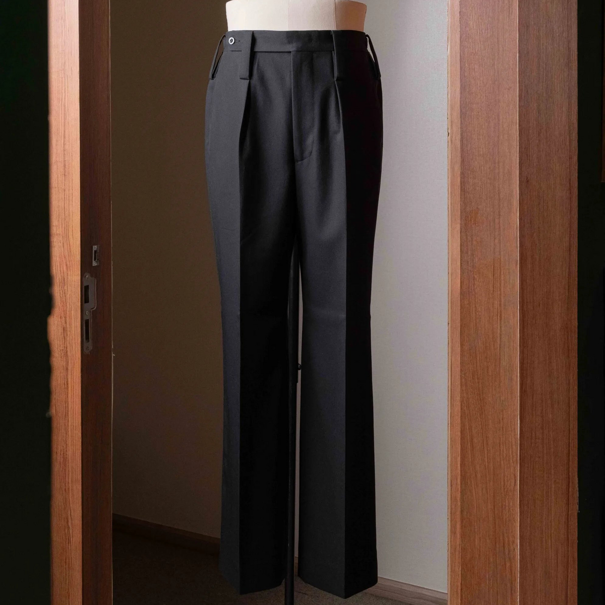 Full-length view of the Tangent TAN25 Pat Black trousers, showing the tailored silhouette and clean structure.