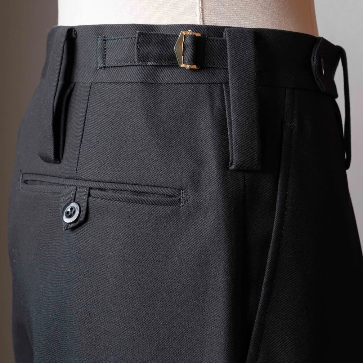 Rear view of the Tangent TAN25 Pat Black trousers featuring the back pockets and refined finishing.
