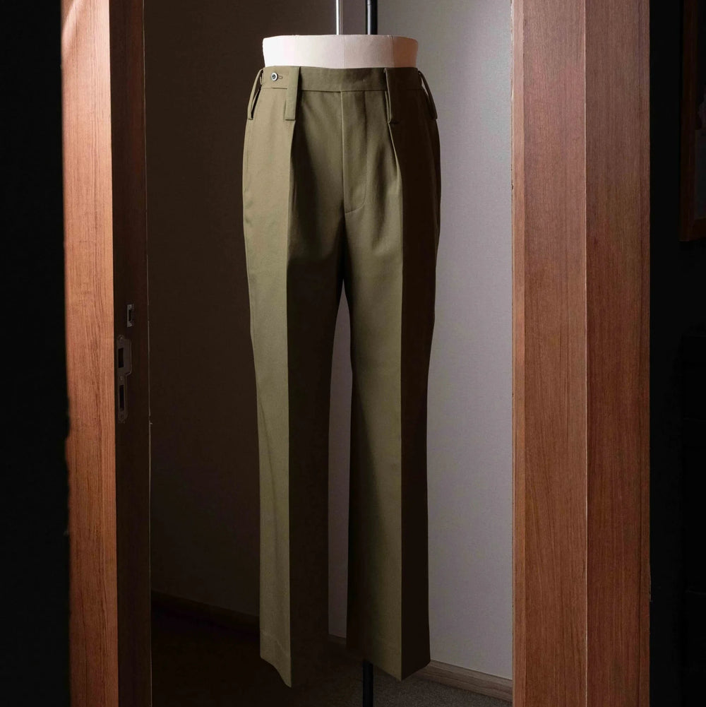Full-length view of the Tangent TAN25 Pat Olive trousers, showing the tailored silhouette and smooth drape.