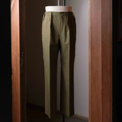 Full-length view of the Tangent TAN25 Pat Olive trousers, showing the tailored silhouette and smooth drape.