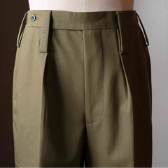 Side profile of the Tangent TAN25 Pat Olive trousers highlighting the clean lines and refined construction.