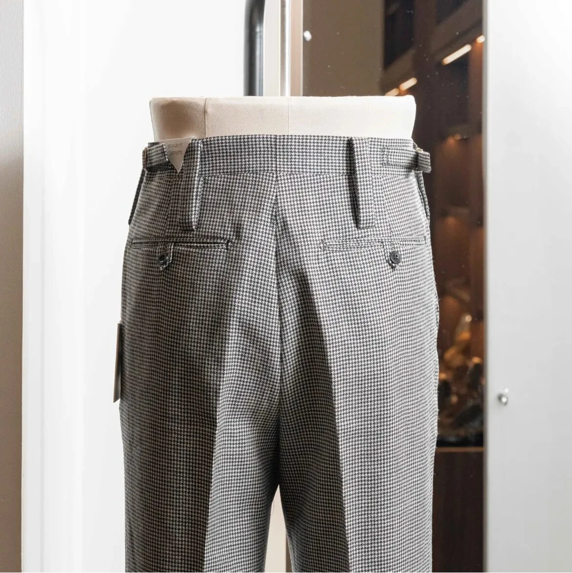 Side profile of the Tangent Tan 25° Wool Check Hound Tooth trousers highlighting the wool texture and clean drape.