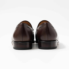 Rear view highlighting the heel shape and craftsmanship of the dark brown vegano tassel loafers.