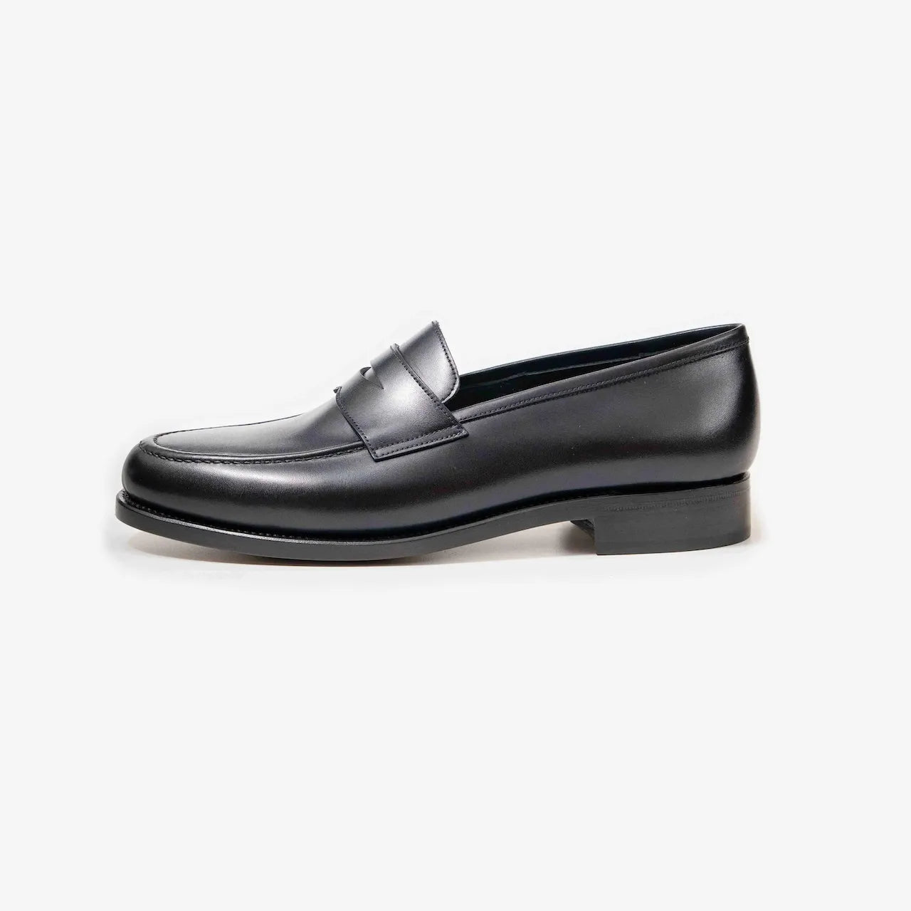 Side profile of the TLB Mallorca Goya Buckled Loafer in black hatch grain leather with a sleek silhouette and single leather sole.