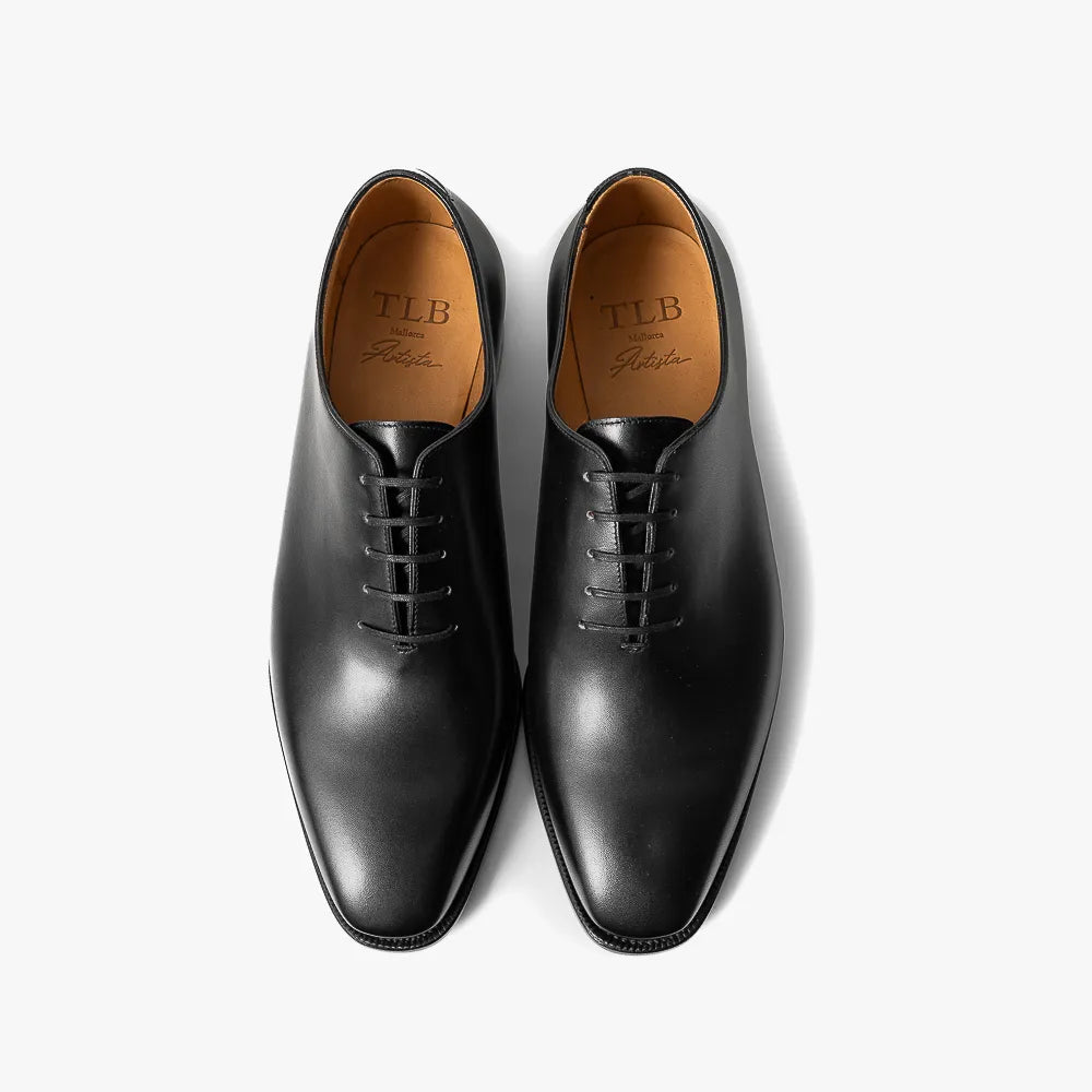 Close-up of the black box calf leather showing smooth grain and polished finish.