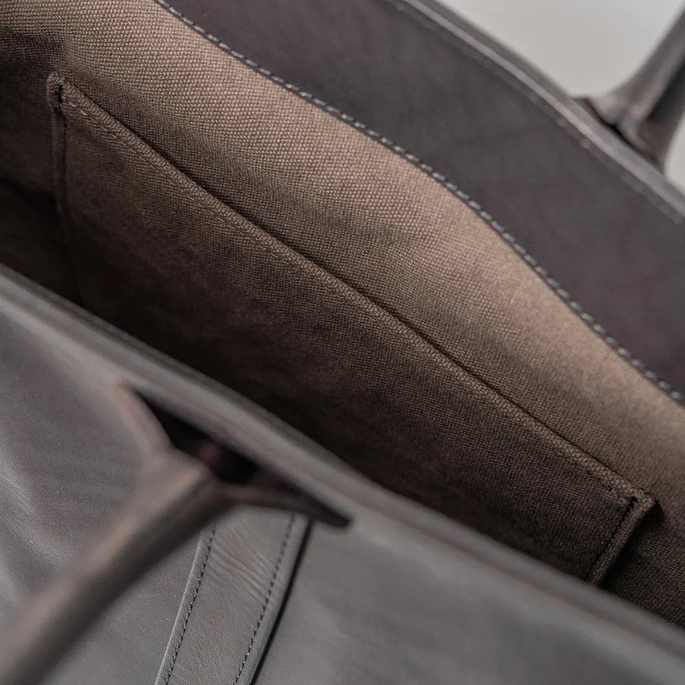 Close-up of the interior slip pocket inside the Vasco x Refinement Leather Tote Black, showing pocket depth, leather finish, and practical storage design.
