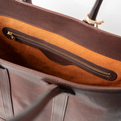 Close-up of the interior zip pocket inside the Vasco x Refinement Leather Tote Brown showing zipper construction and leather lining.