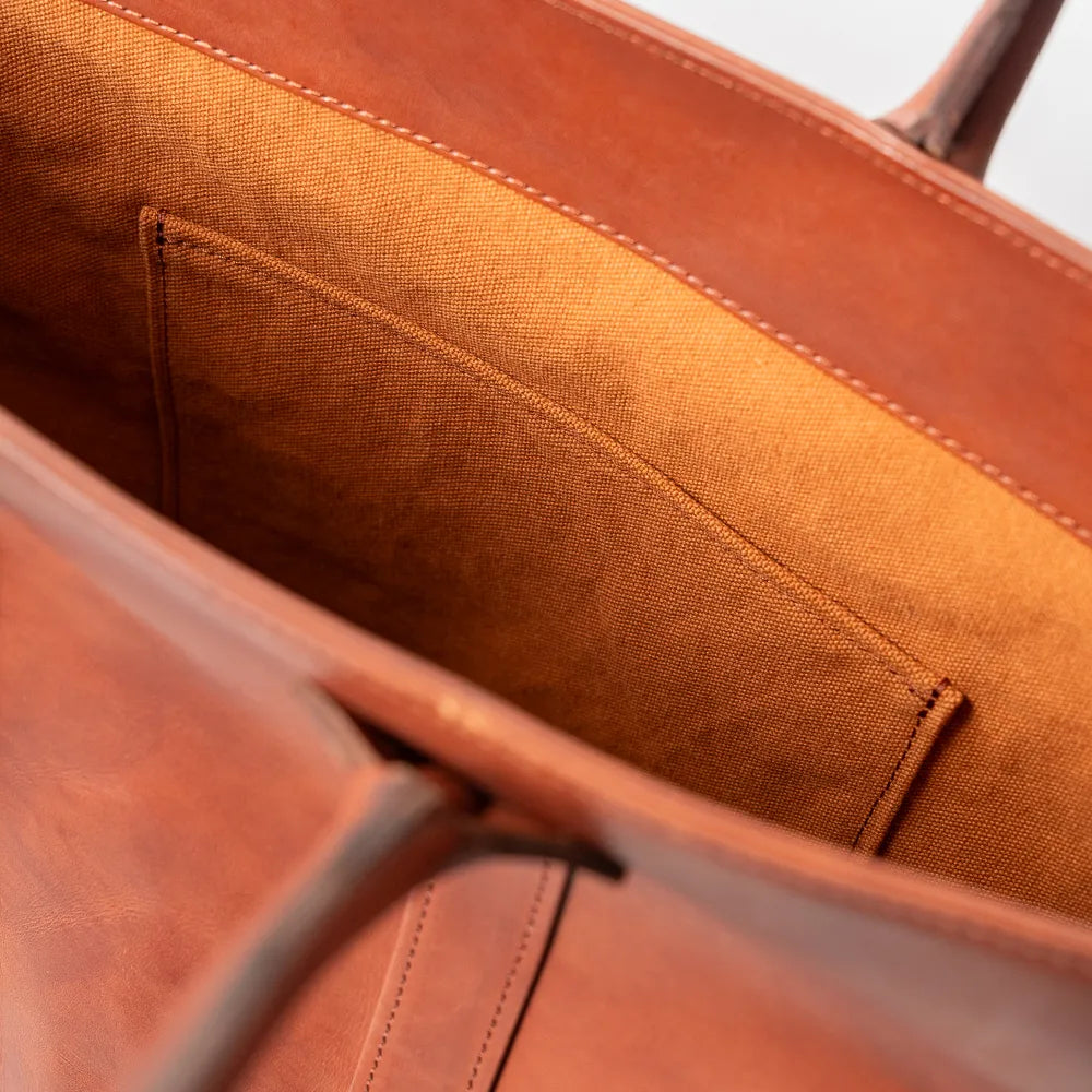 Close-up of the interior slip pocket inside the Vasco x Refinement Leather Tote Camel showing practical storage and leather finish.